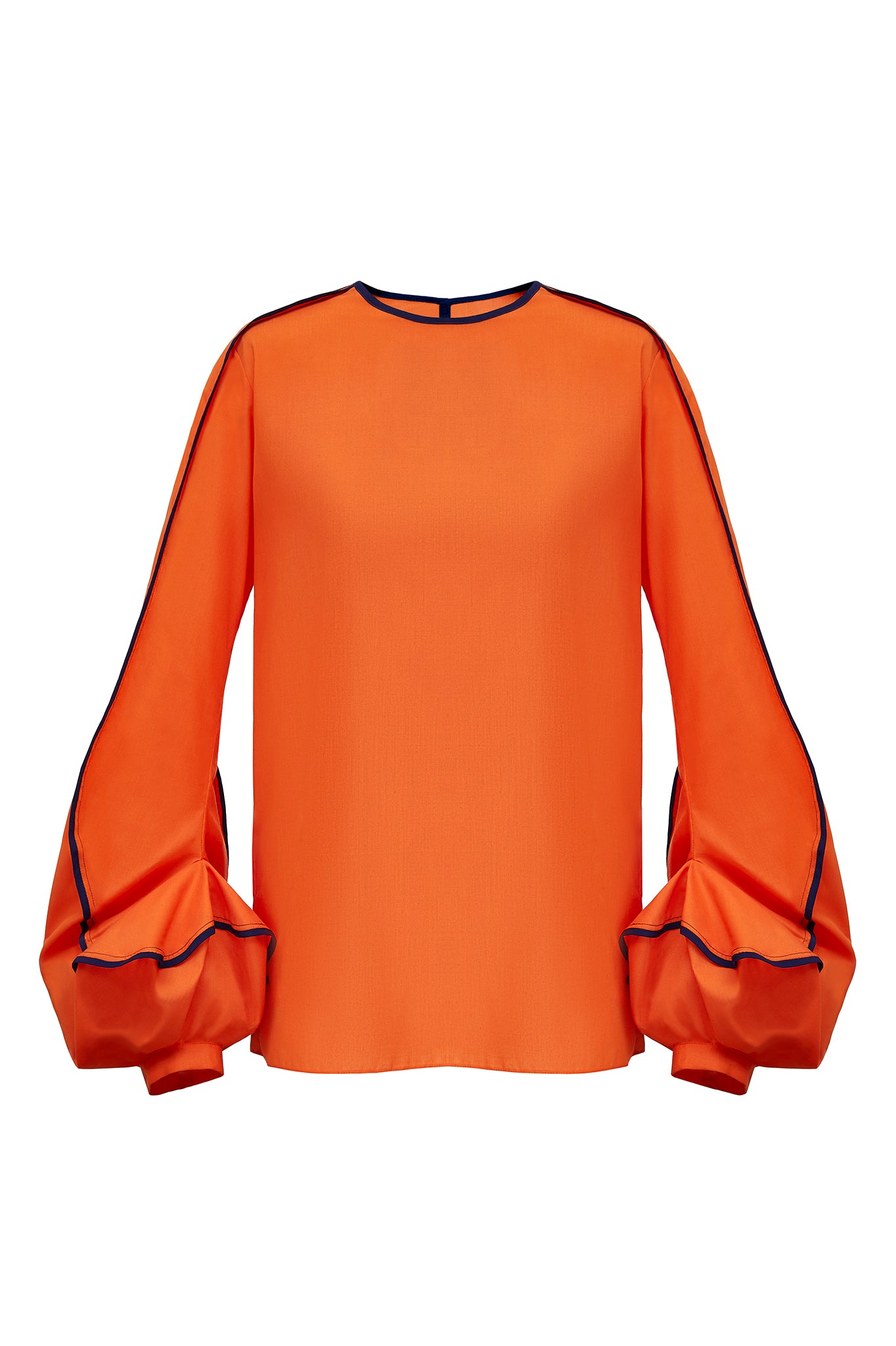 This blouse has the most unusual cuff detailing. Designed to emulate the swirl of the “Erupt” dress, the sleeve is bottom heavy and features two contrasting bound edges, highlighting the erratic movement of the seam work.  This piece has a simple straight, clean fit in the body, with a split seam in the back to open. Available on this page in either orange with navy blue binding, or red with black binding.