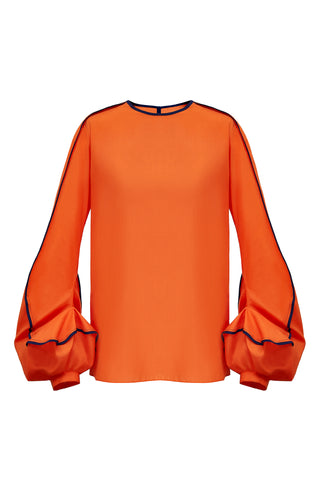 This blouse has the most unusual cuff detailing. Designed to emulate the swirl of the “Erupt” dress, the sleeve is bottom heavy and features two contrasting bound edges, highlighting the erratic movement of the seam work.  This piece has a simple straight, clean fit in the body, with a split seam in the back to open. Available on this page in either orange with navy blue binding, or red with black binding.