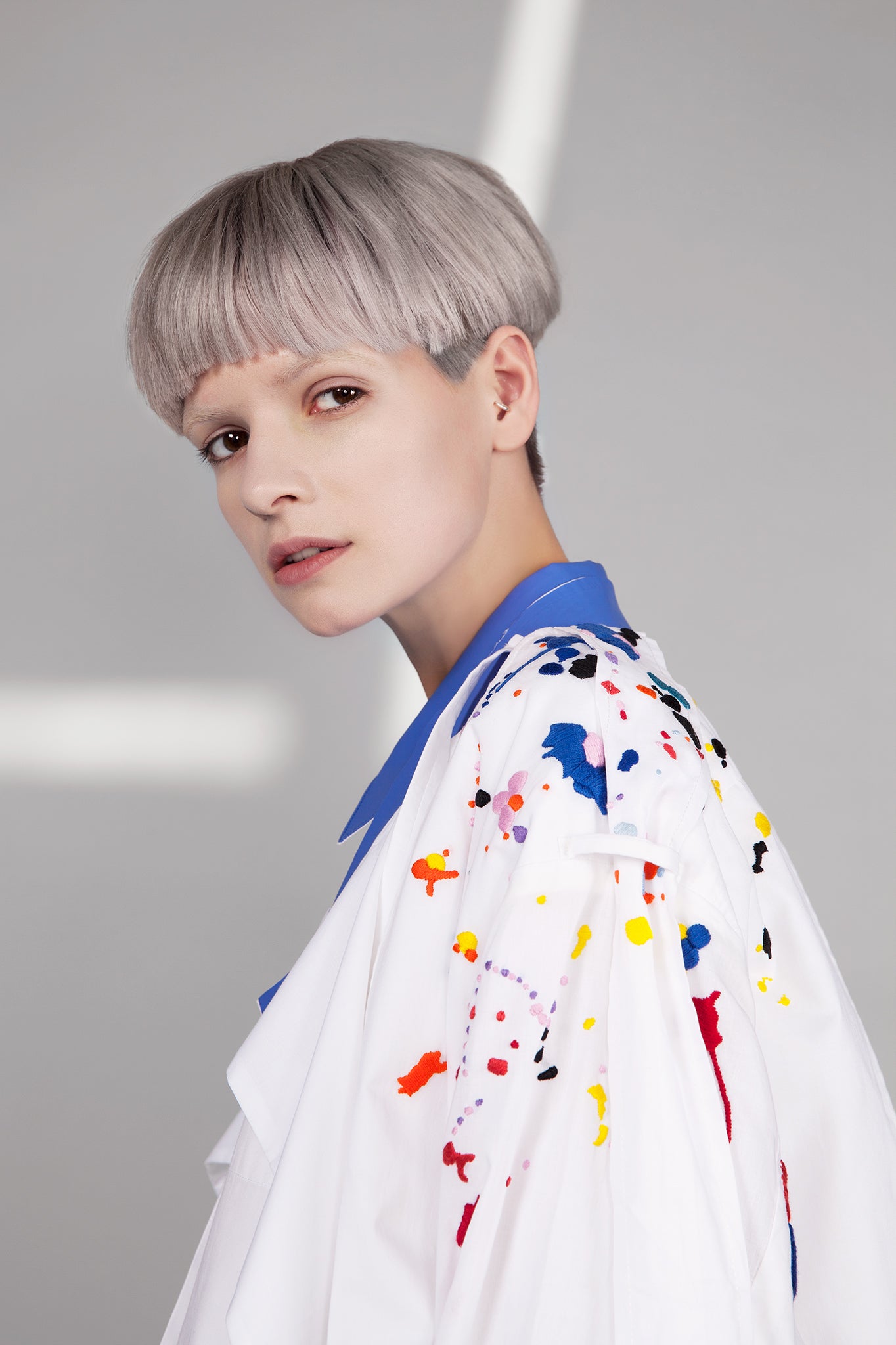 Colourful embroidered paint splashes on crisp white cotton 'Helios' trench coat from emerging brand CIMONE. Embellishments and overall look at echoed by Oscar de la Renta one year later in SS18 - be ahead of the trends and support new brands!
