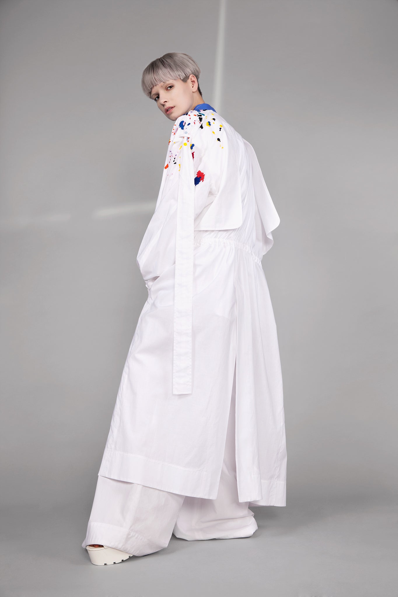Colourful embroidered paint splashes on crisp white cotton 'Helios' trench coat from emerging brand CIMONE. Embellishments and overall look at echoed by Oscar de la Renta one year later in SS18 - be ahead of the trends and support new brands!