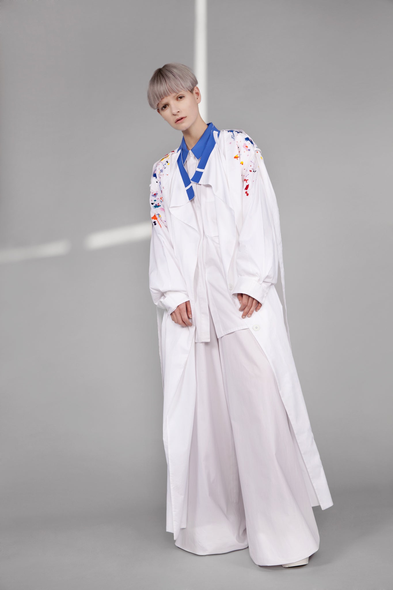 Colourful embroidered paint splashes on crisp white cotton 'Helios' trench coat from emerging brand CIMONE. Embellishments and overall look at echoed by Oscar de la Renta one year later in SS18 - be ahead of the trends and support new brands!
