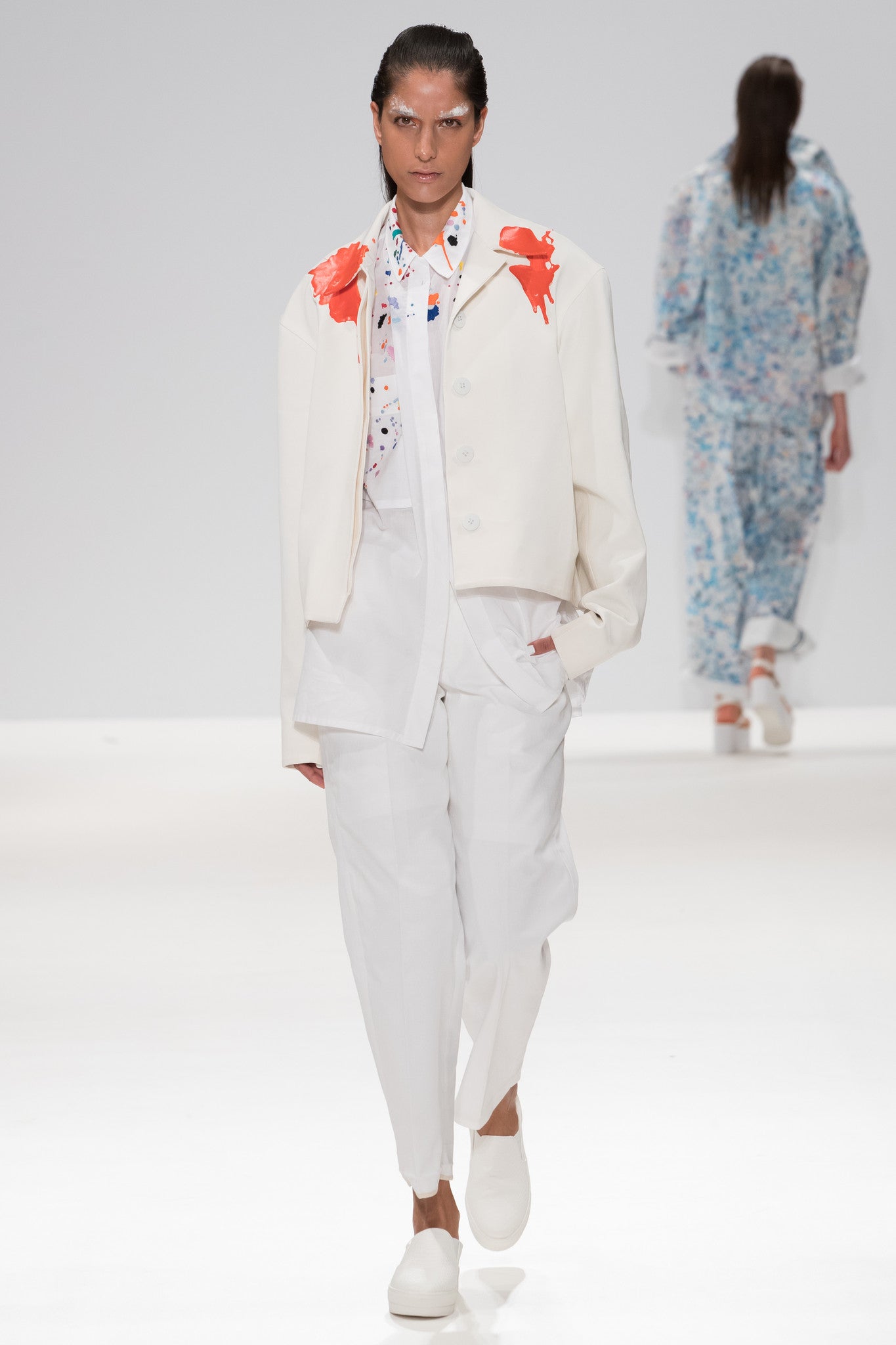 SS17 catwalk image from CIMONE'S show, showing colourful embroidered paint splashes on crisp white cotton 'cleave' shirt from emerging brand CIMONE. Embellishments and overall look at echoed by Oscar de la Renta one year later in SS18 - be ahead of the trends and support new brands! Worn with an orange rubberised paint drip collar version of out white cropped bomber - "flight jacket"